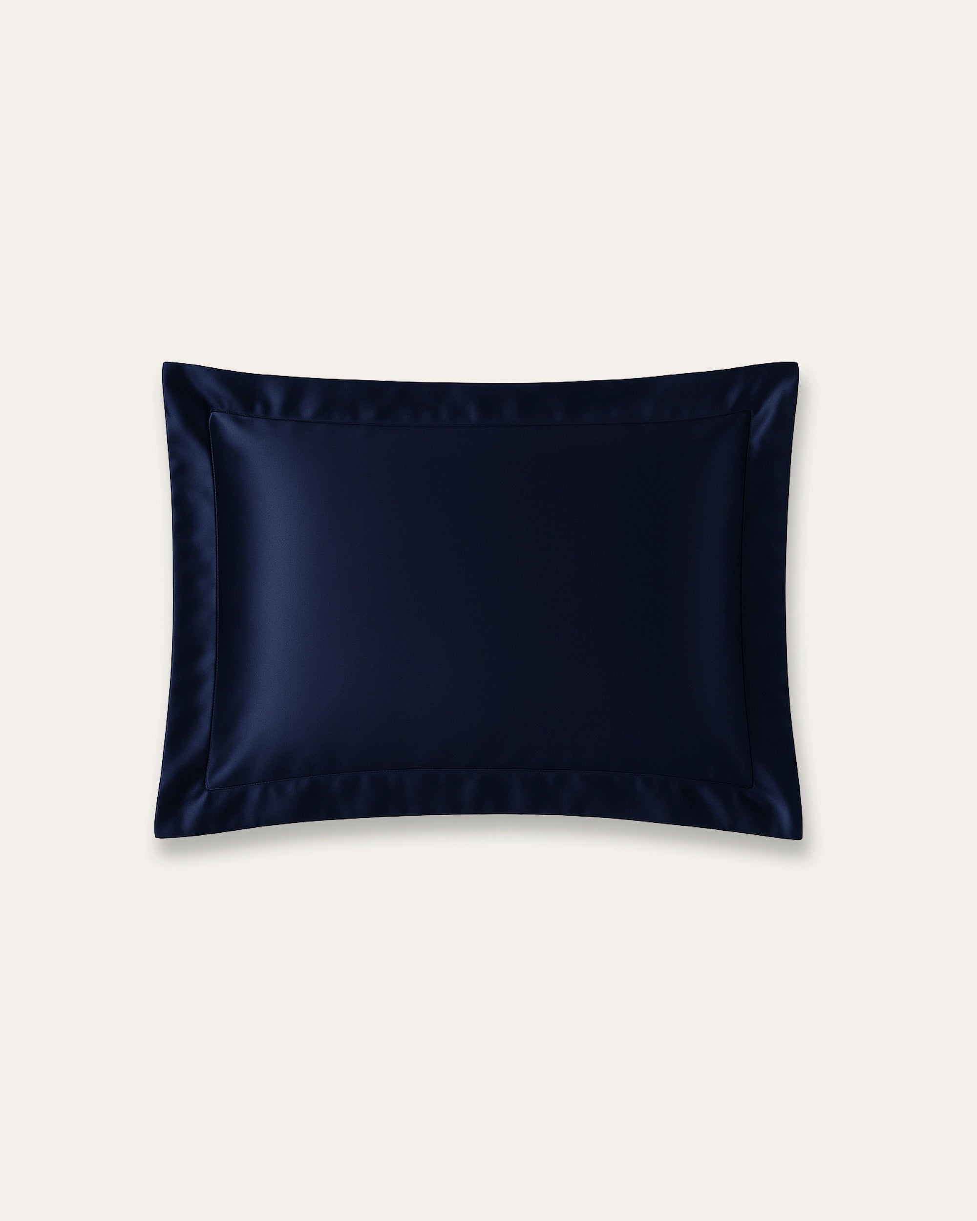 Midnight blue satin Oxford pillowcase with structured trim for luxury and hair protection.