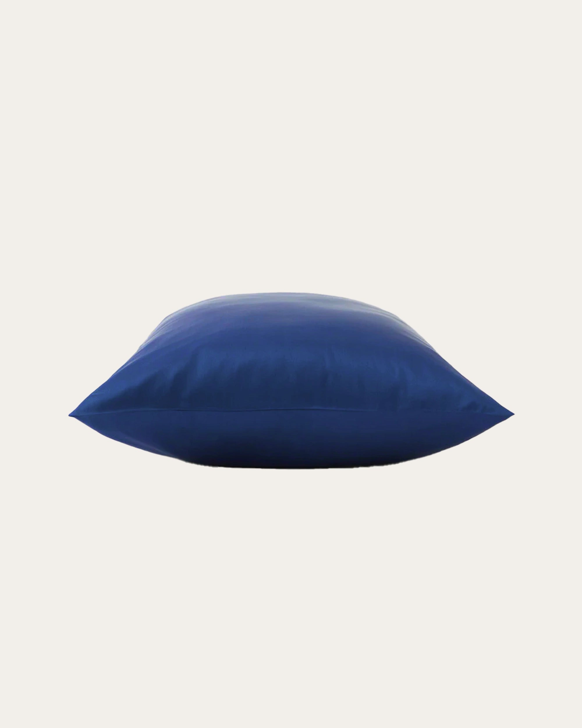 Blue satin square pillowcase on a bed, adding elegance and comfort to your bedroom decor.