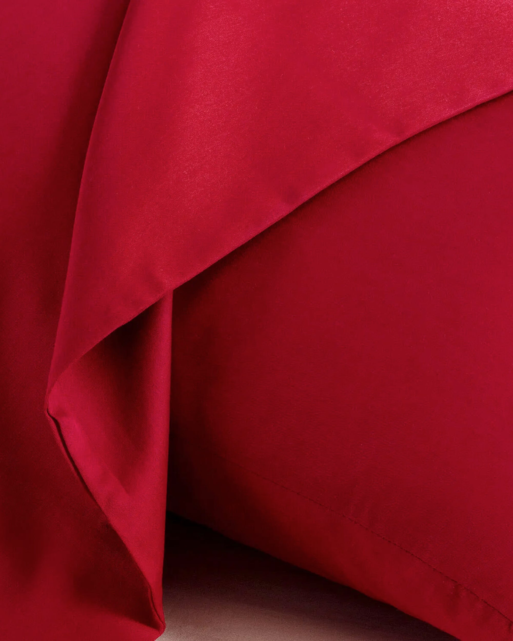 Close-up of Imperial Red Satin Pillowcase, showcasing its smooth texture and vibrant color for a luxurious bedding experience.