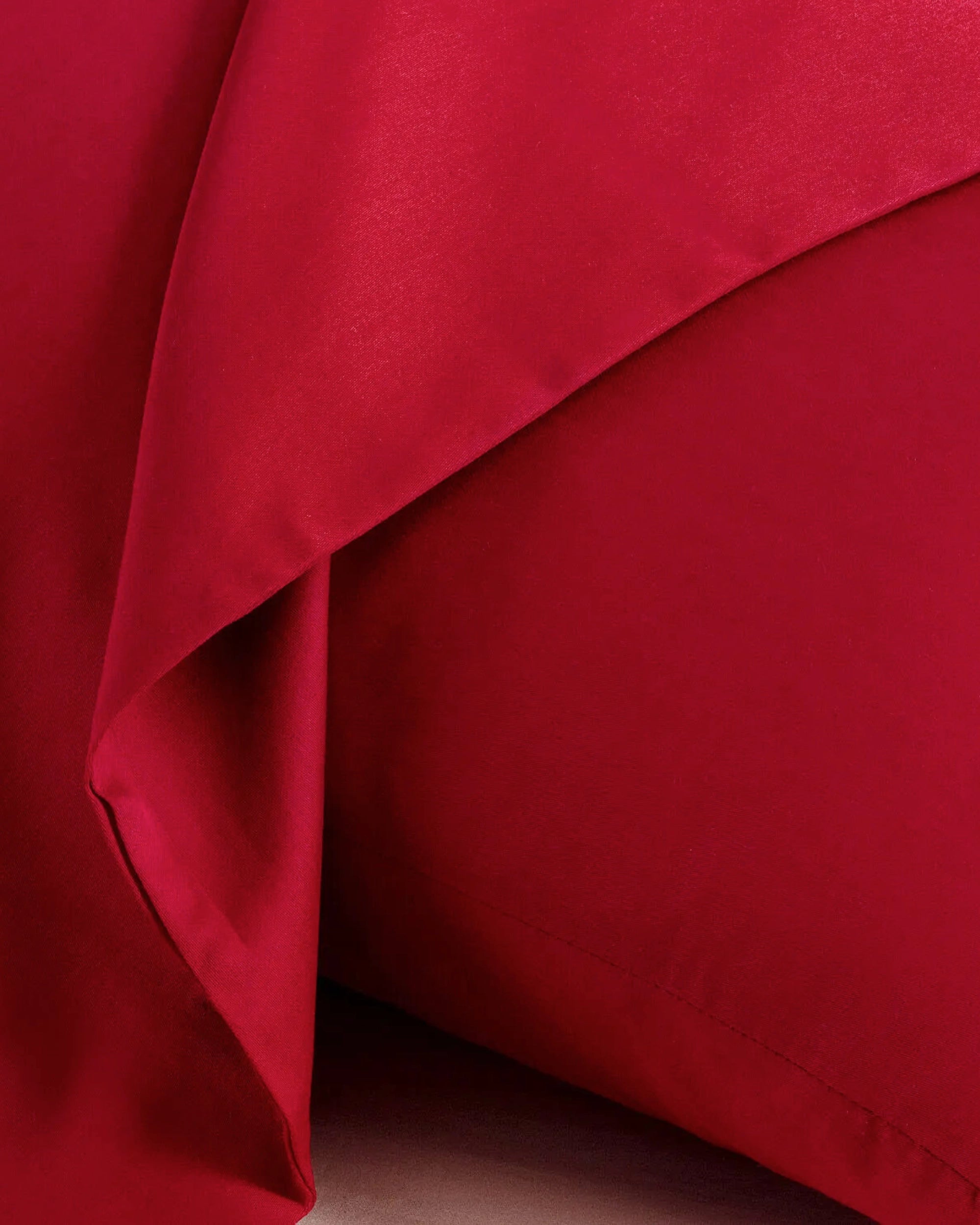 Elegant imperial red satin square pillowcase close-up, showcasing its luxurious texture and rich color.