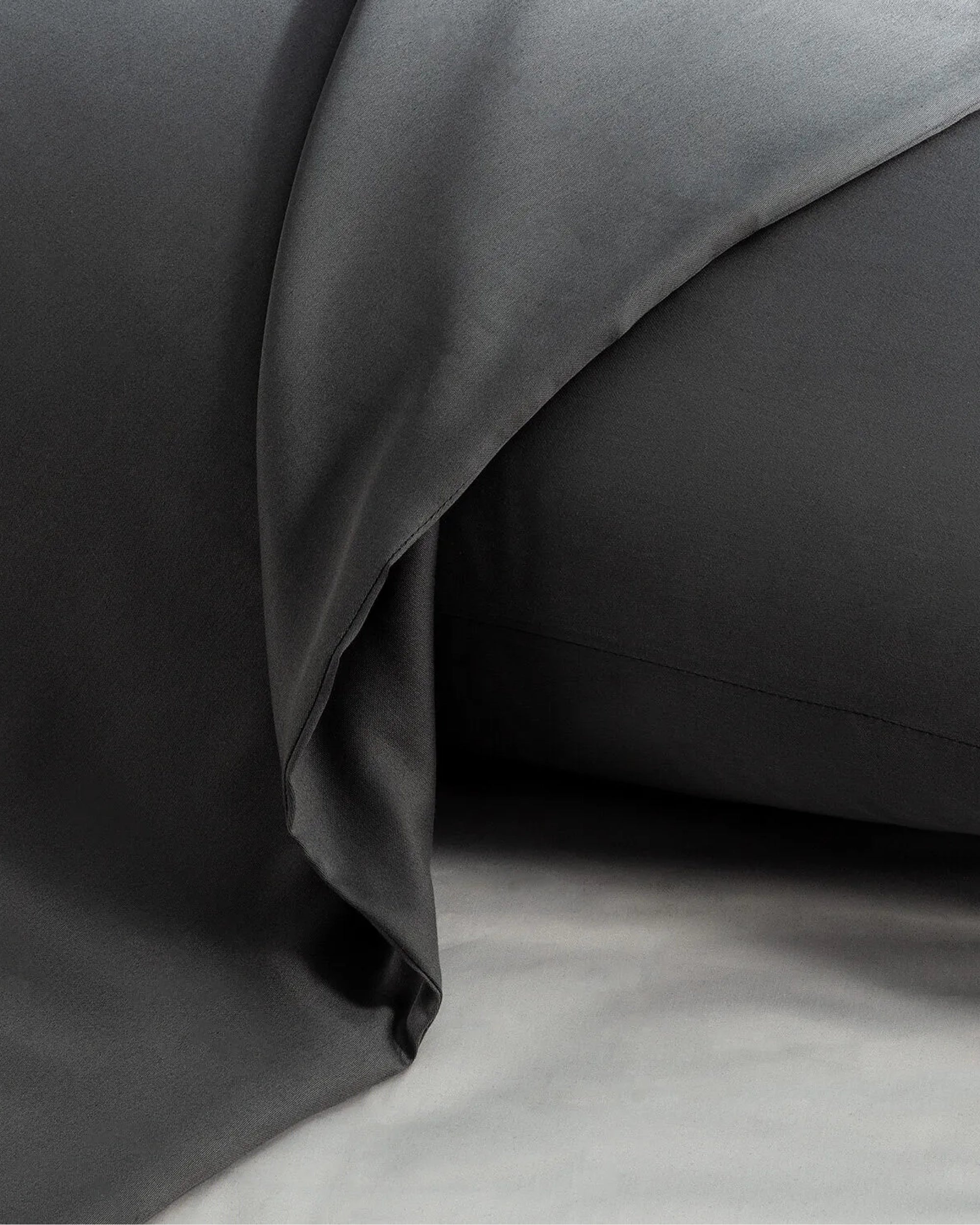 Moonlight Silver Satin Square Pillowcase showcasing cool elegance and metallic sheen on a smooth surface.