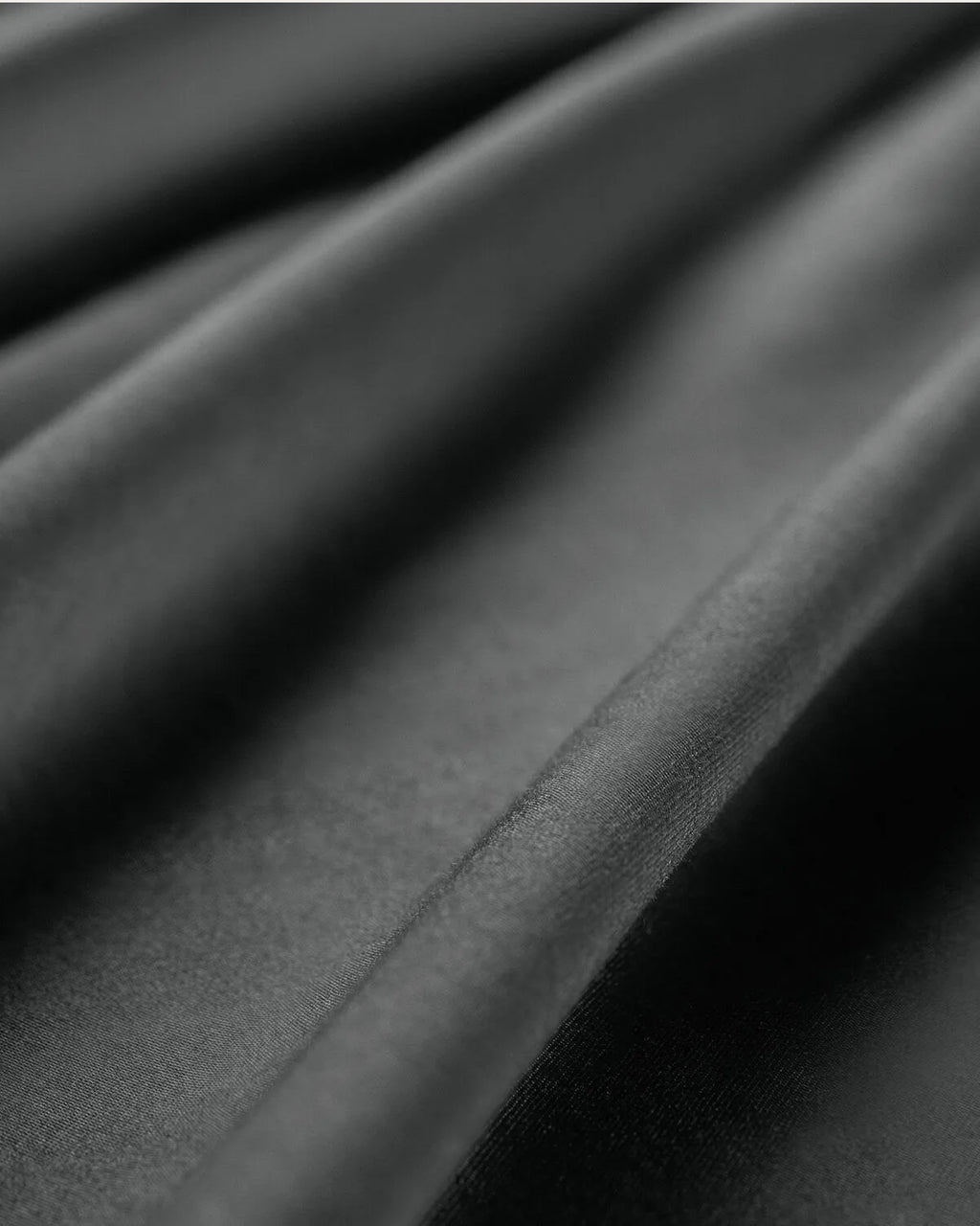 Moonlight Silver satin pillowcase on a bed, adding elegance and comfort to your bedroom decor.