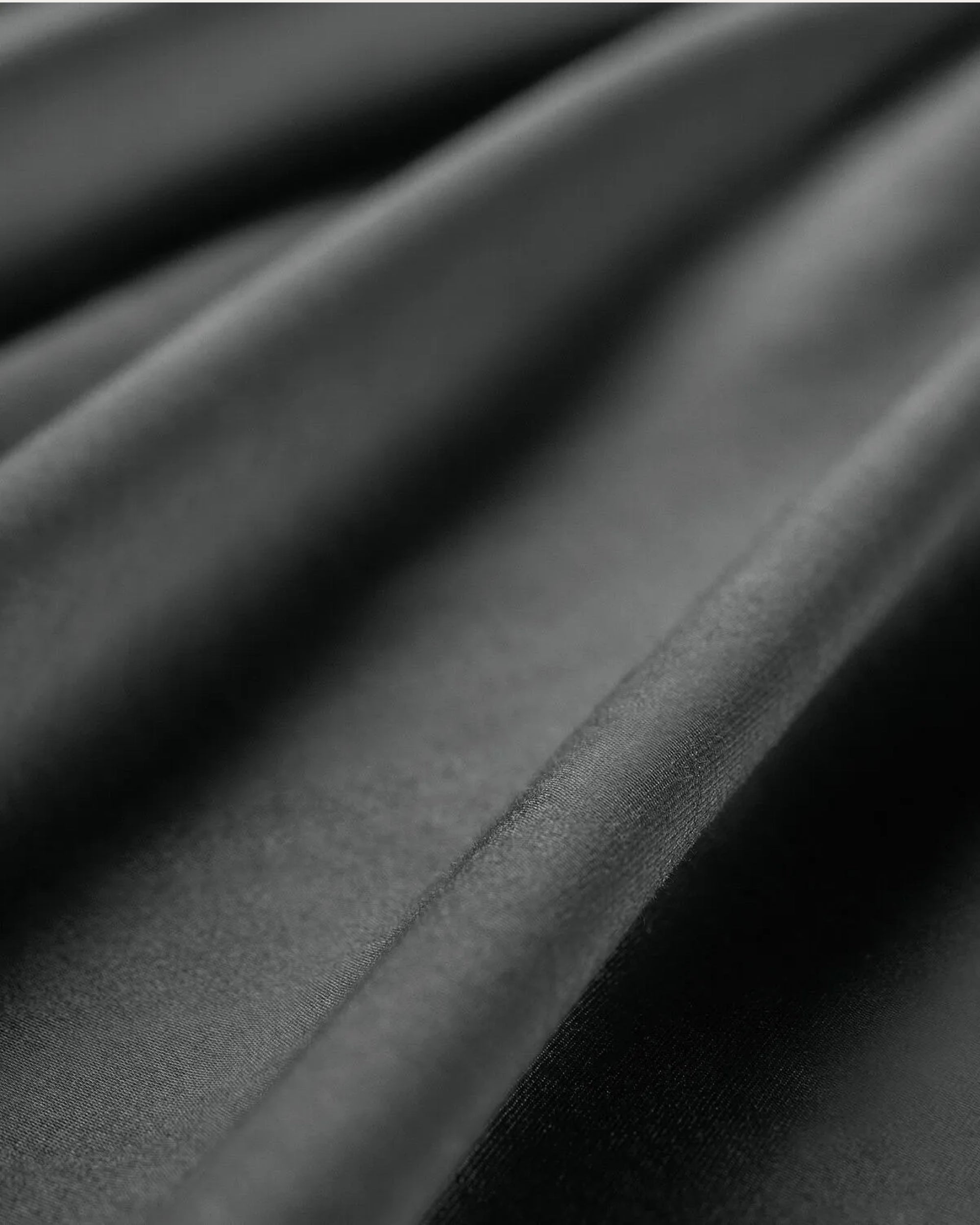 Moonlight Silver satin pillowcase on a bed, adding elegance and comfort to your bedroom decor.