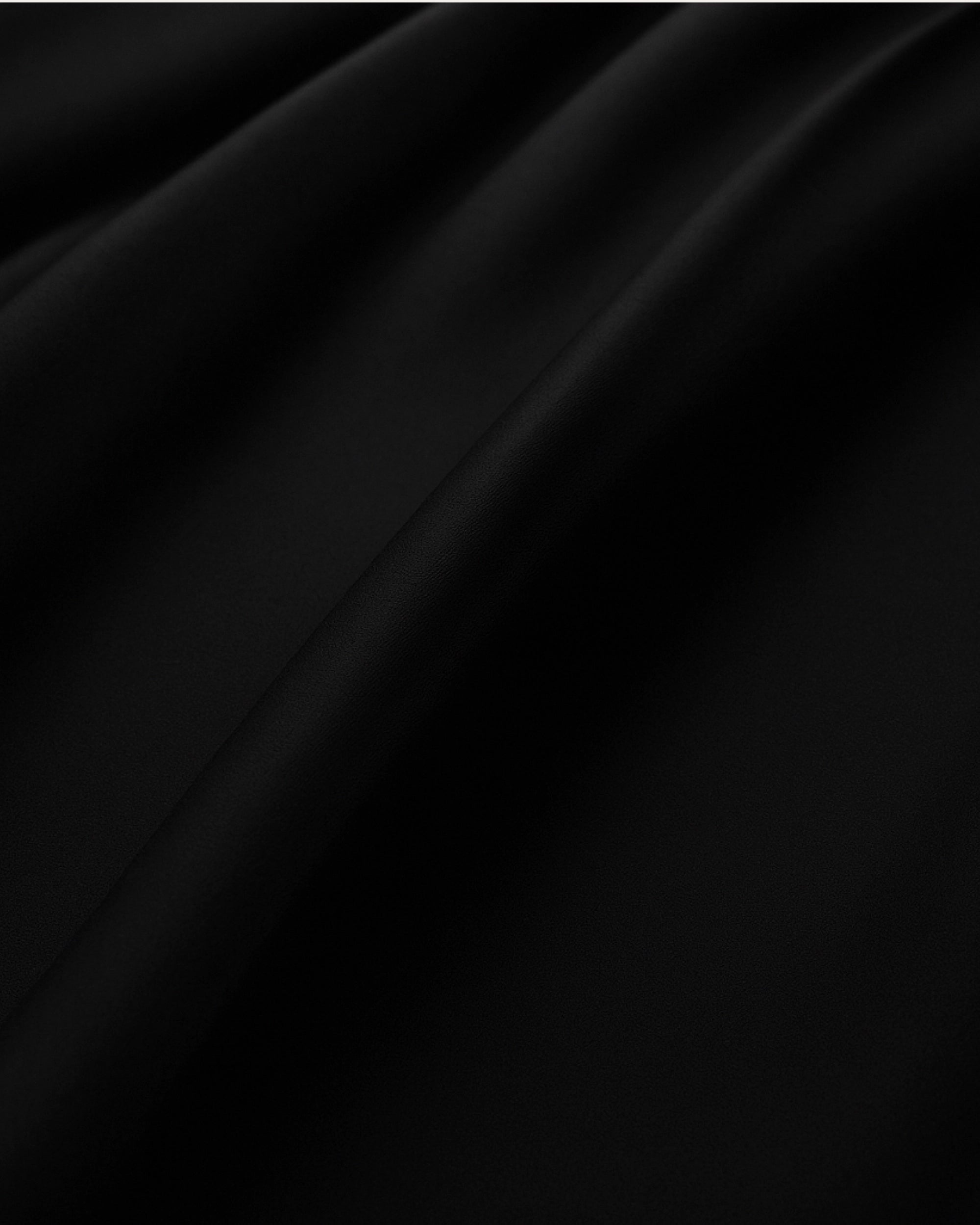 Close-up of a black velour satin fabric showcasing its smooth texture and rich color.